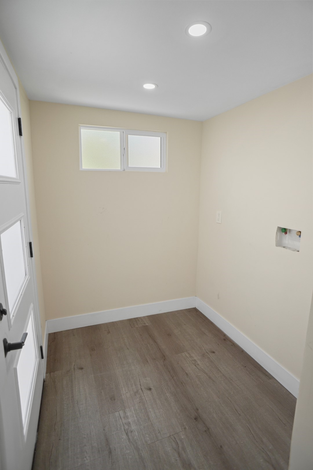 Laundry area with back door